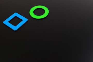 Black school chalk and magnet board with magnet paper note.