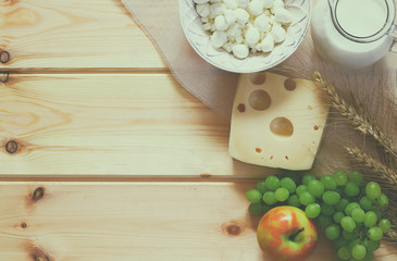Fototapeta na wymiar image of dairy products and fruits on wooden background