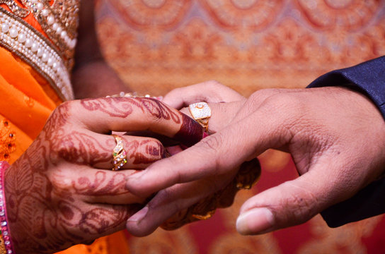 Groom Wearing Wedding Ring With His Bride