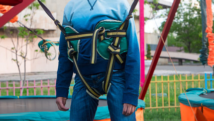 Safety belt for jumping on boy in park