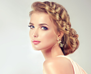 Beautiful model girl with elegant hairstyle . Beautiy woman with fashion wedding hair and colourful...