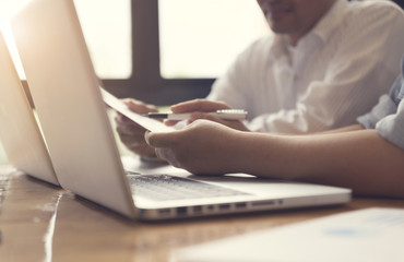 people working together with laptop computer