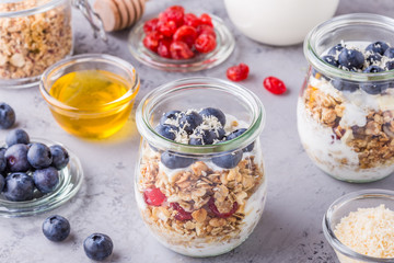 Healthy breakfast - glass jars of oat flakes with fruit,yogurt.