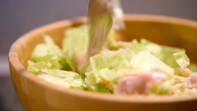 Home Preparing Caesar Salad In Wooden Bowl