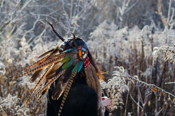 Modern Indian-style girl in a horned and feathered hat