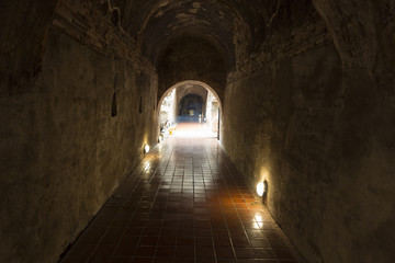 golden buddha statue in cave tunnel