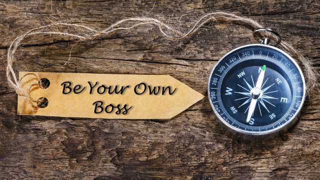 Be your own boss - Motivation handwriting on label with compass