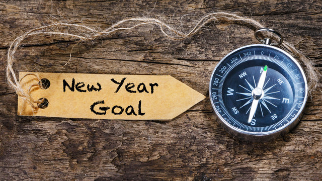 New year goals - motivation handwriting on label with compass