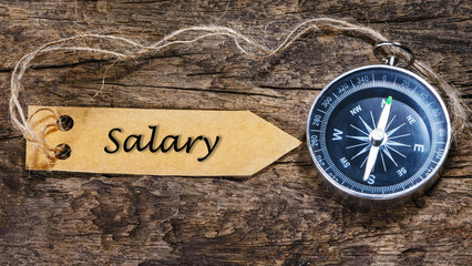 Salary - Concept handwriting on label with compass