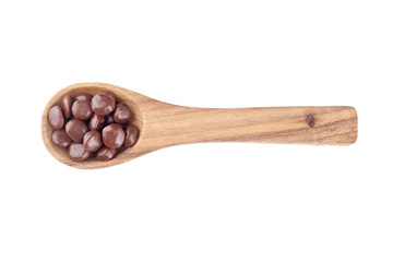 chocolate candies in a wooden ladle