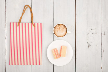 meeting in a cafe - a cup of coffee, waffles and shopping pack