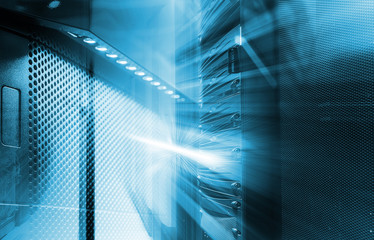 Obraz premium ranks of modern server hardware in data center with blur and motion