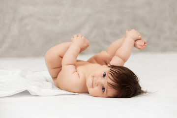 Portrait of baby girl lying on blanket at home © Wrangler