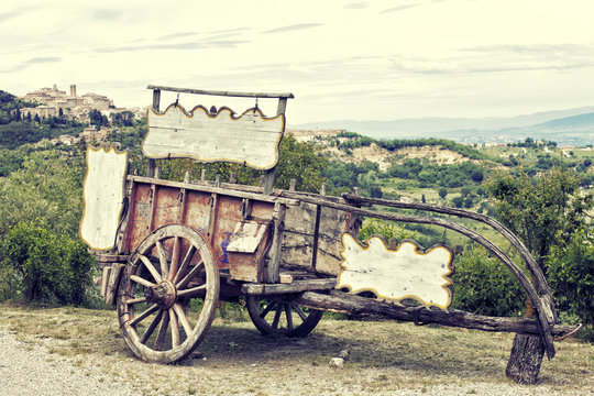 Old wooden cart against vineyards, Tuscany, Italy. Processing in retro style