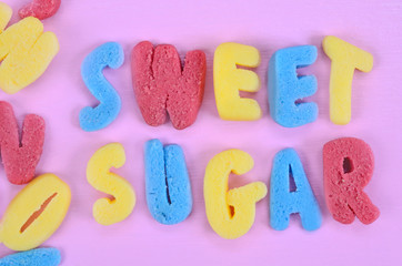 Words Sweet Sugar on pink table