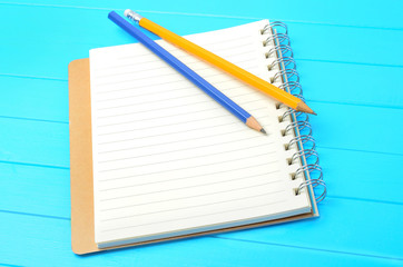 Empty notebook with pencils