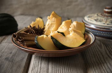 Pumpkin in a clay dish with spices
