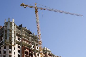 Construction crane on the building background