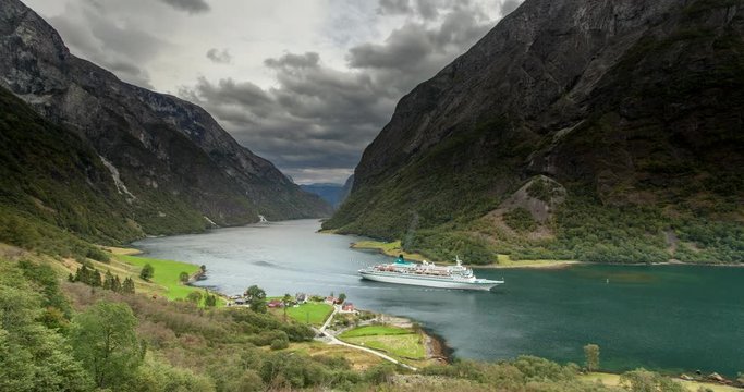 Ship cruises in fjord in Naeroyfjord near Gudvangen, Norway - 4K Timelapse