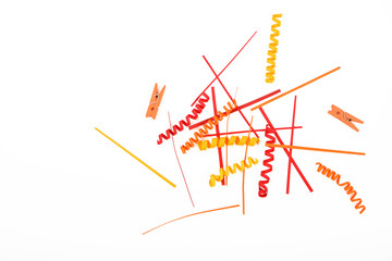 Red and yellow paper and clothespins on white