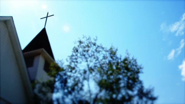 Altered footage of a cross on a church steeple useful as a foreshadowing shot for something strange or foreboding. Handheld stylized footage.
