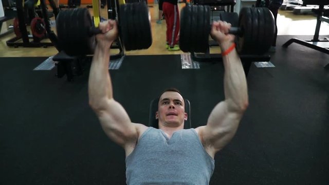 footage guy doing exercise dumbbell bench press at the gym.