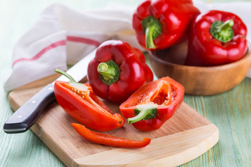 Fresh organic bell peppers on a wooden board
