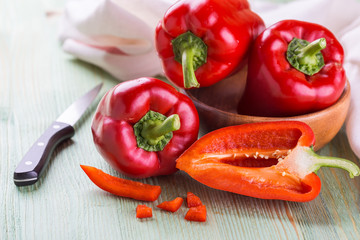 Fresh organic bell peppers on a wooden board