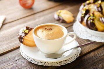 cup of coffee with homemade cookies on arustic  wooden table with capsule