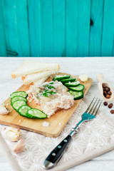 
Ukrainian and Russian national cuisine , the dish is called brawn , boiled pork and turkey in jelly of bouillon with fresh cucumber , salt and spices on a wooden background
