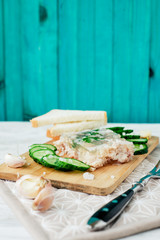 
Ukrainian and Russian national cuisine , the dish is called brawn , boiled pork and turkey in jelly of bouillon with fresh cucumber , salt and spices on a wooden background