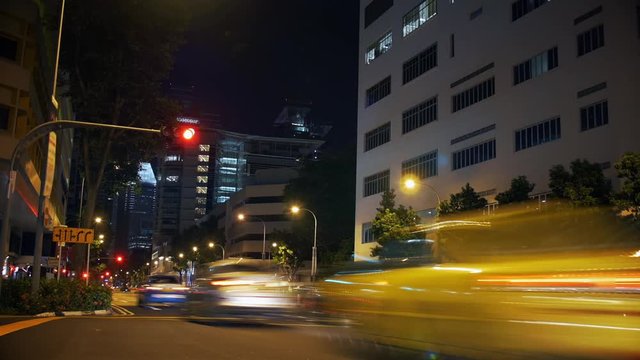 Cinemagraph of traffic in a big city (Singapore) where the traffic is frozen in time and the only thing moving are the traffic lights going from green to red and back. Looping motion background loop.