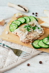 
Ukrainian and Russian national cuisine , the dish is called brawn , boiled pork and turkey in jelly of bouillon with fresh cucumber , salt and spices on a wooden background