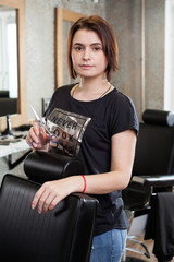 Woman barber with scissors at work