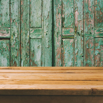 Empty wooden deck table over old wooden boads background