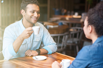 Cute boyfriend and girlfriend resting in restaurant