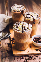 Homemade coffee cocktail with whipped cream and liquid chocolate
