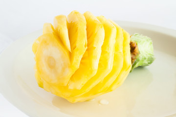 Whole ripe peeled pineapple on white background