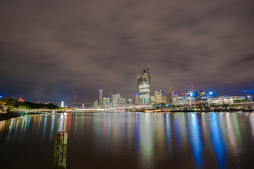 Fototapeta na wymiar Brisbane city skyline lights across river at night from South Bank of Brisbane River