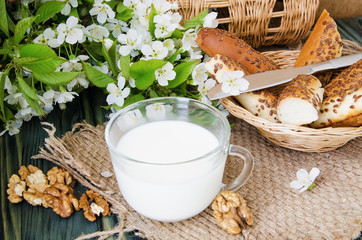  cup of milk with fresh pastries and nuts