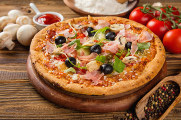 Rustic pizza with ingredients, top view