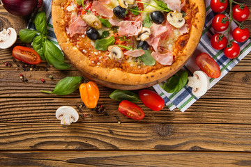 Rustic pizza with ingredients, top view