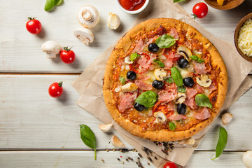 Rustic pizza with ingredients, top view