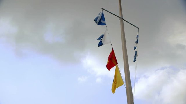 maritime signal flags waving in the breeze
