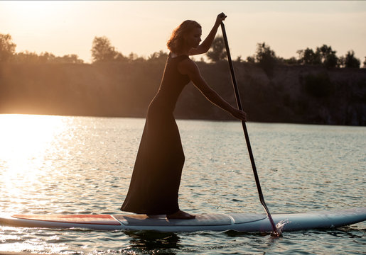 silhouette of a beautiful woman on stand up paddle board. SUP03