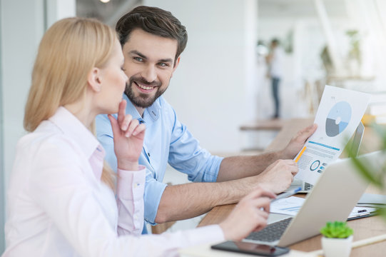 Cheerful two colleagues are working together