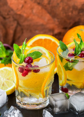 Lemonade - a refreshing drink made of citrus and berries with mint and ice. Selective focus
