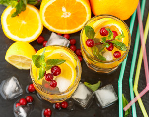 Lemonade - summer refreshing drink made of citrus and berries with mint and ice. Selective focus
