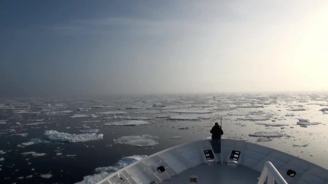 Dawn in the ocean among the icebergs and ice in the Arctic. Fantastic wonderful amazing video grenland nature iceland. Lovely shooting the life of nature, seaside and mountains. Global warming.