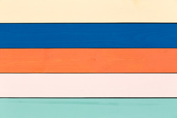 Colorful stained wood background in pastels